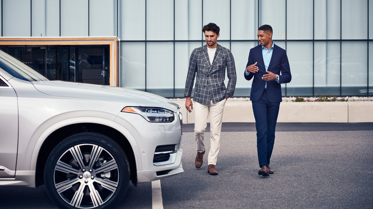 Specialist walking near a Volvo